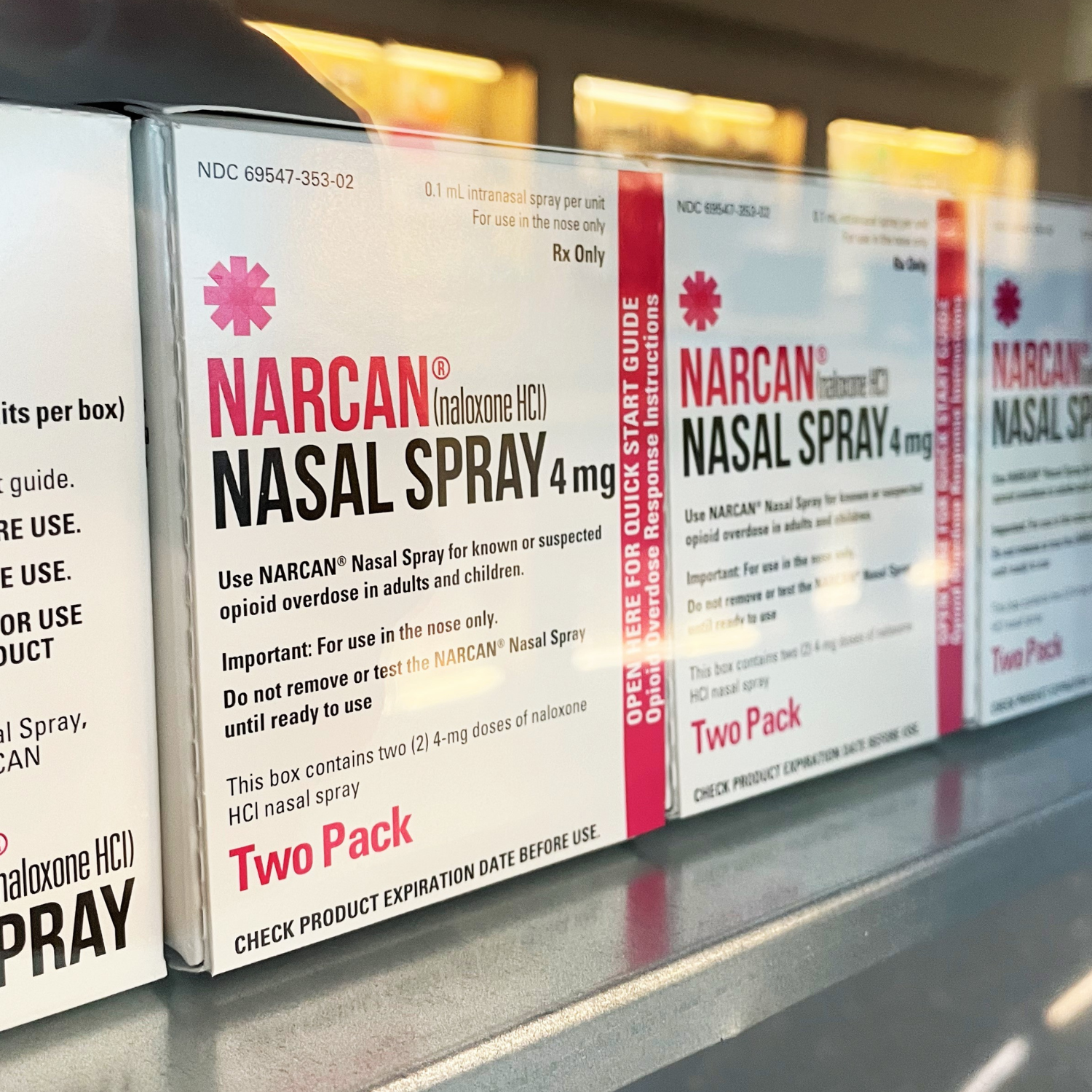 Boxes of the medication Narcan lined up behind glass