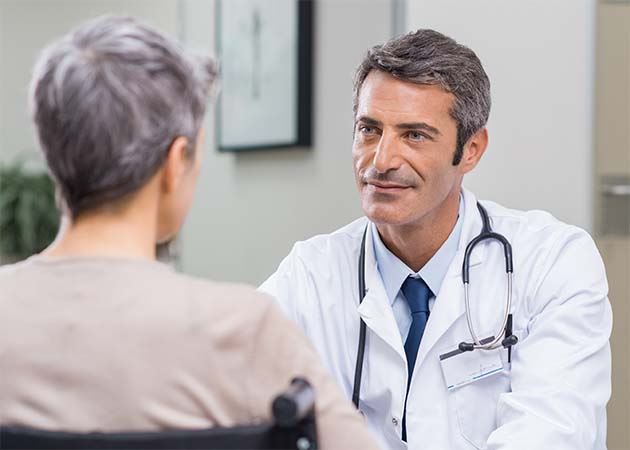 Male doctor speaking with patient