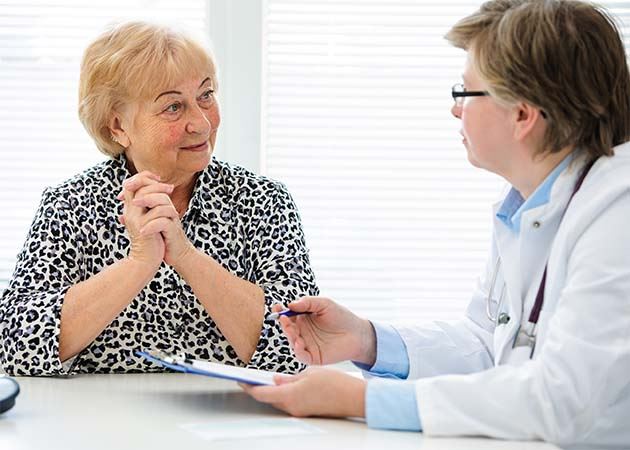 Senior patient talking with doctor